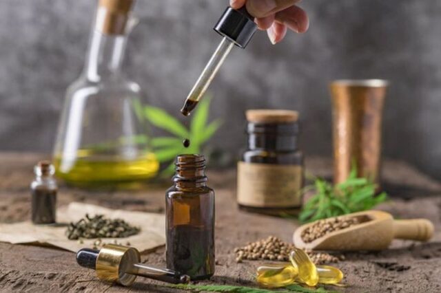 cannabis essential oil container with cannabis leaves and cannab